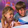 A boy and girl enjoy playing a game together at Disney’s Art of Animation Resort